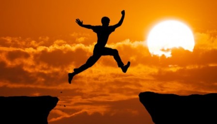 Man leaping over a canyon in the sunset happiness, vacation, be happy