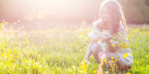 Woman in meadow at sunset